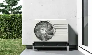 Unidad exterior de aerotermia sin placas solares, instalada junto a una pared blanca y un jardín verde.