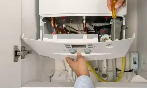 Instalador ajusta caldera de gas natural. Aprovecha el plan renove calderas gas natural Castilla y León para modernizar tu hogar.