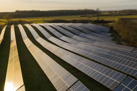 Campo de paneles solares capturando la luz del atardecer, mostrando los usos de la energía solar para un futuro sostenible.
