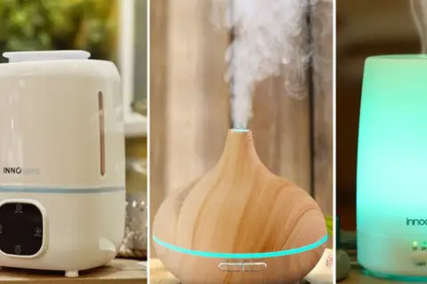 Tres dispositivos: un humidificador blanco con panel de control, un difusor de madera con vapor y un humidificador/purificador iluminado en verde.