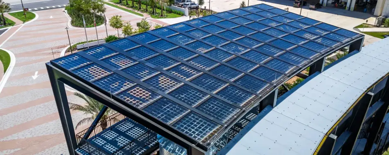 Un moderno tejado fotovoltaico, cubierto de paneles solares, se alza sobre una estructura metálica, capturando la energía del sol.