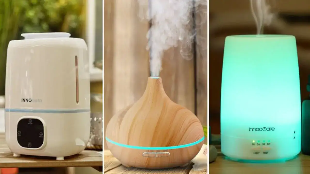 Tres humidificadores o purificadores de aire en diferentes estilos: uno blanco grande, uno de madera con luz azul y uno transl&uacute;cido verde.